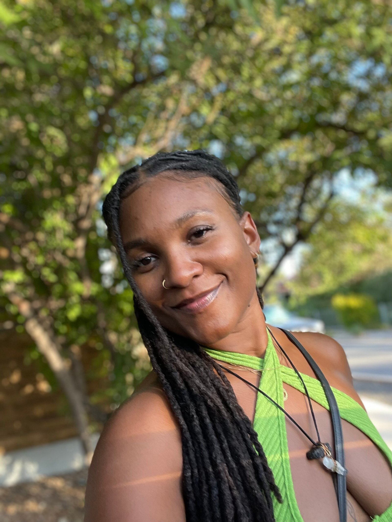 Kiera standing outside wearing a green top